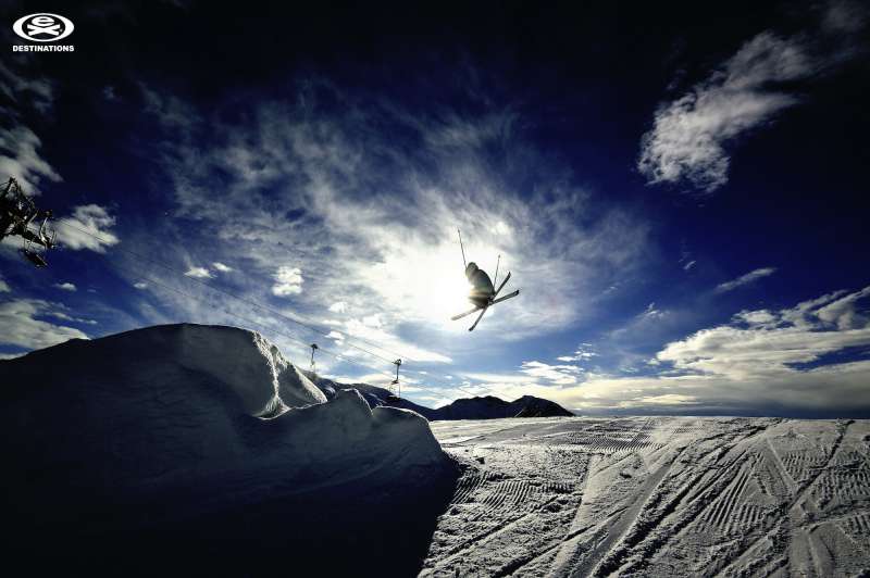 extreme skier mid-air on slopes