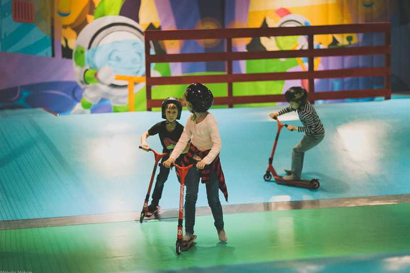 kids on scooters indoor play