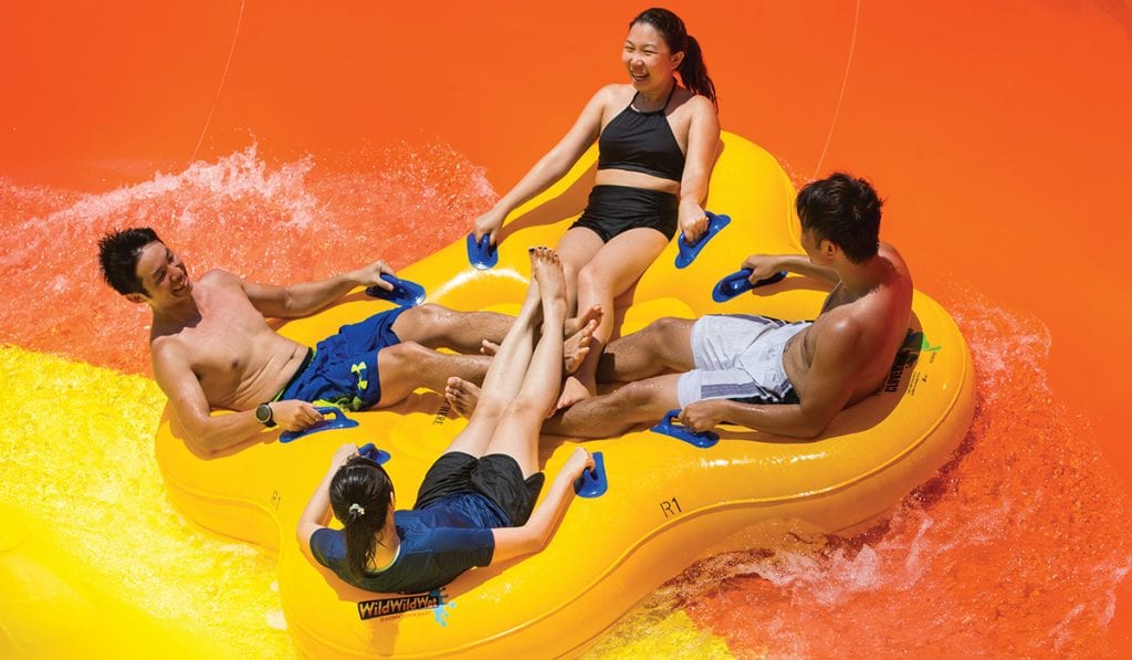 Close up view of four riders in a clover leaf raft