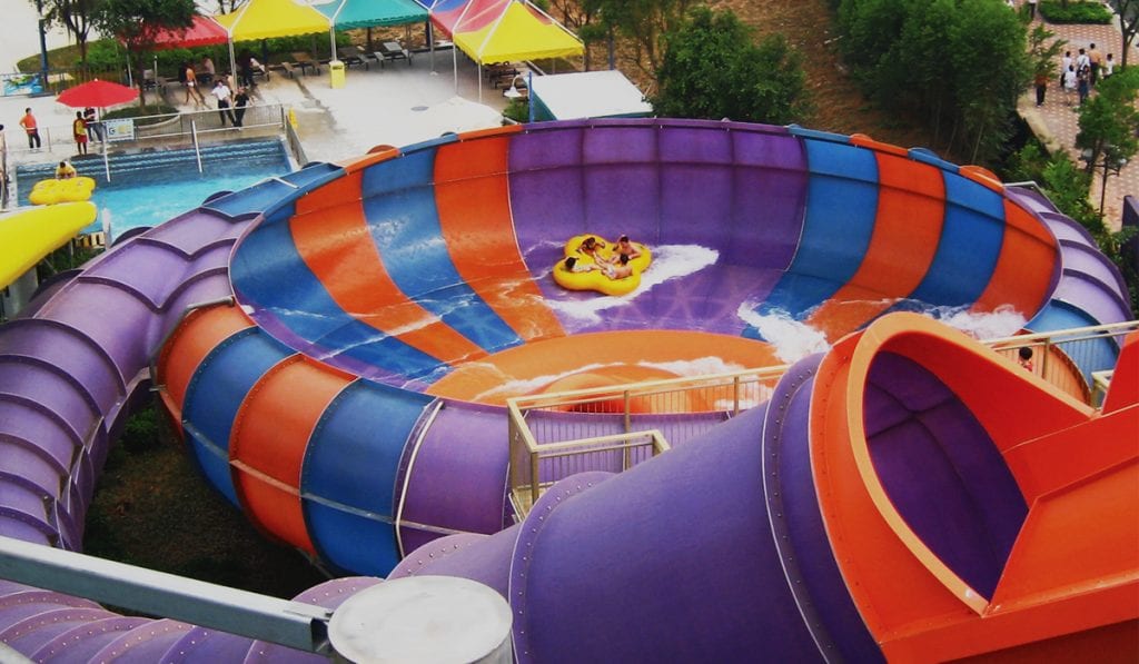 Landscape image of a two person raft traveling along the walls of a purple and orange behemoth bowl 60