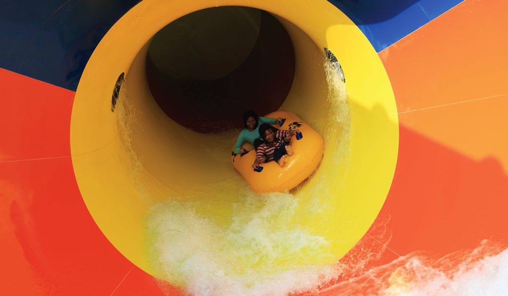 Inside view of two individuals on a yellow raft as tehy are about to exit a pipeline