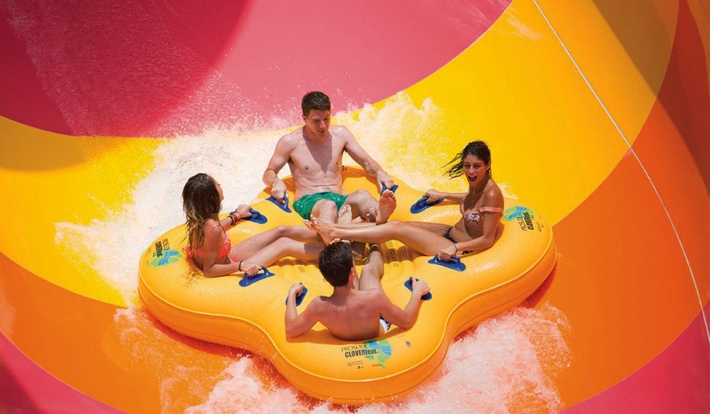 Close-up of four riders on a yellow raft