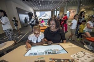 Mother and daughter interacting with education panel at the Cleveland Museum of Art