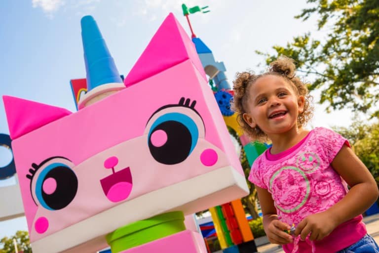 Young girl poses with Unikitty lego at Legoland Florida