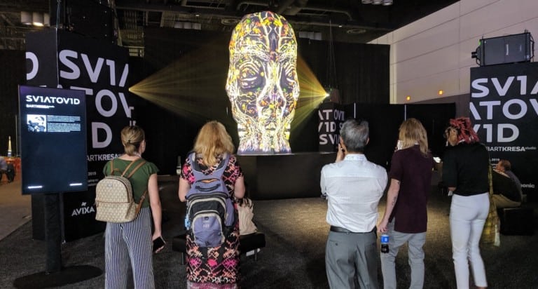 visitors watch Bart Kresa's Sviatovid projection mapping sculpture at infocomm 2019 copy