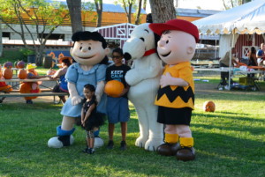 young fans pose with Peanuts characters