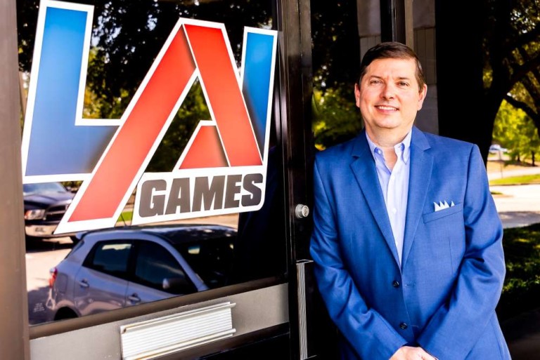 John Bugh standing in front of LAI Games sign