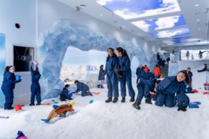 Children playing in powdered snow at Ice Now Frostland