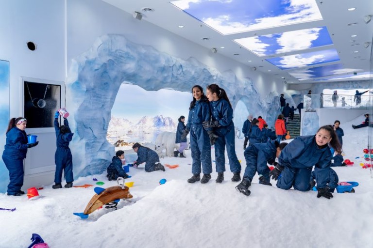 Children playing in powdered snow at Ice Now Frostland