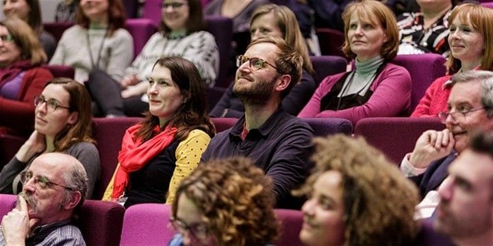 People sitting in a conference theatre at let's get real conference