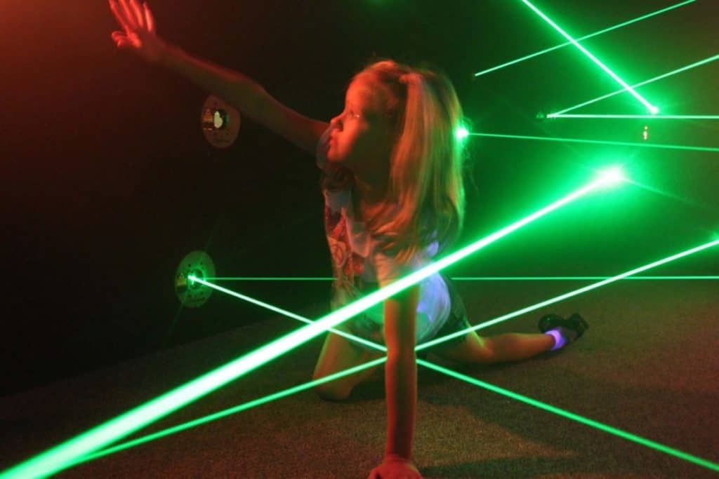 Girl playing the lazer maze challenge from Funovation