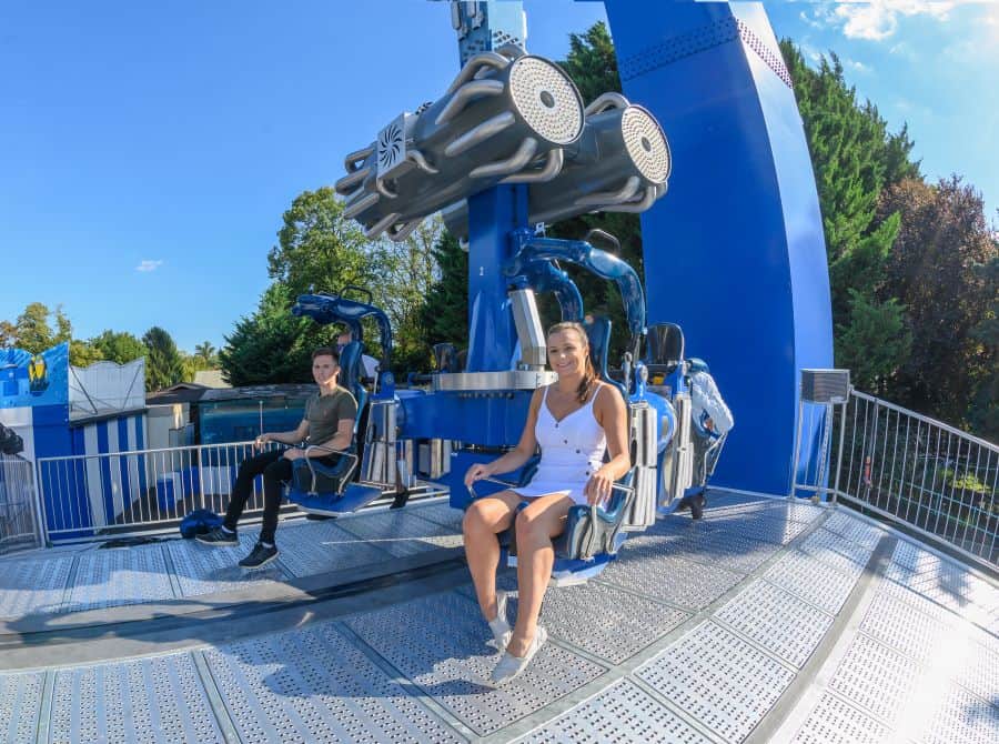 Riders sitting on Ride Entertainment's Booster Unhinged ride