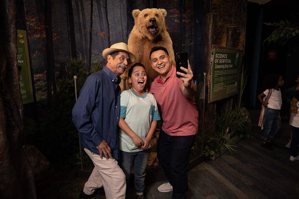 A Family takes a photo in Survival the Exhibition