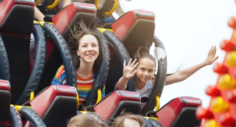 Young friends on roller coaster ride.