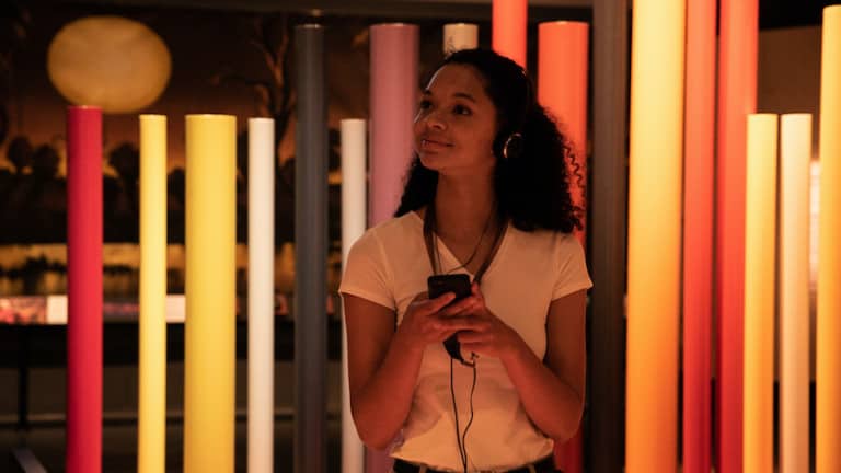 Young woman listening to audio tour in Boola Bardip