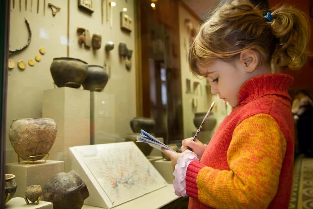 young girl at museum with exhibits