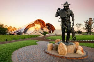 Large bronze statue of stockman outside museum building