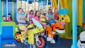 Family on LEGOLAND New York brick carousel ride