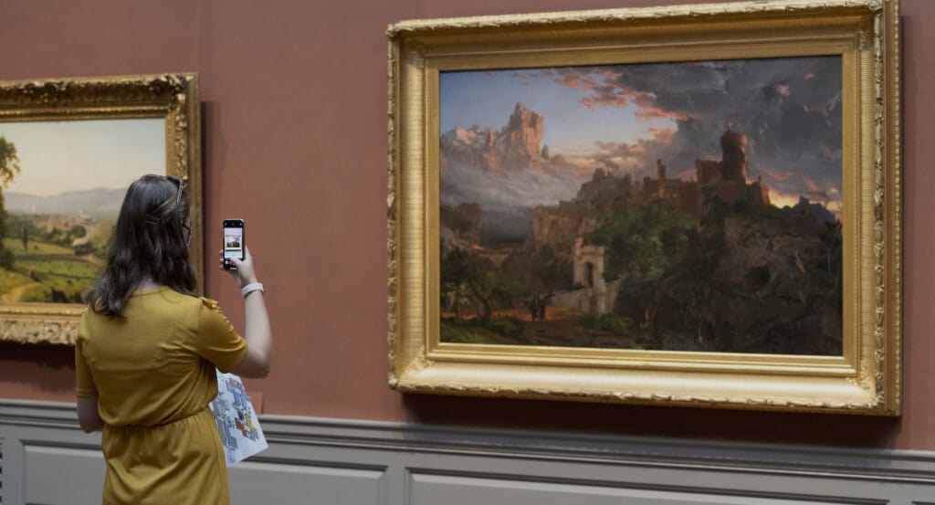 A visitor captures Jasper Francis Cropsey’s The Spirit of War, National Gallery of Art, Washington