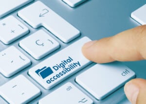 finger pressing button on keyboard that reads digital accessibility