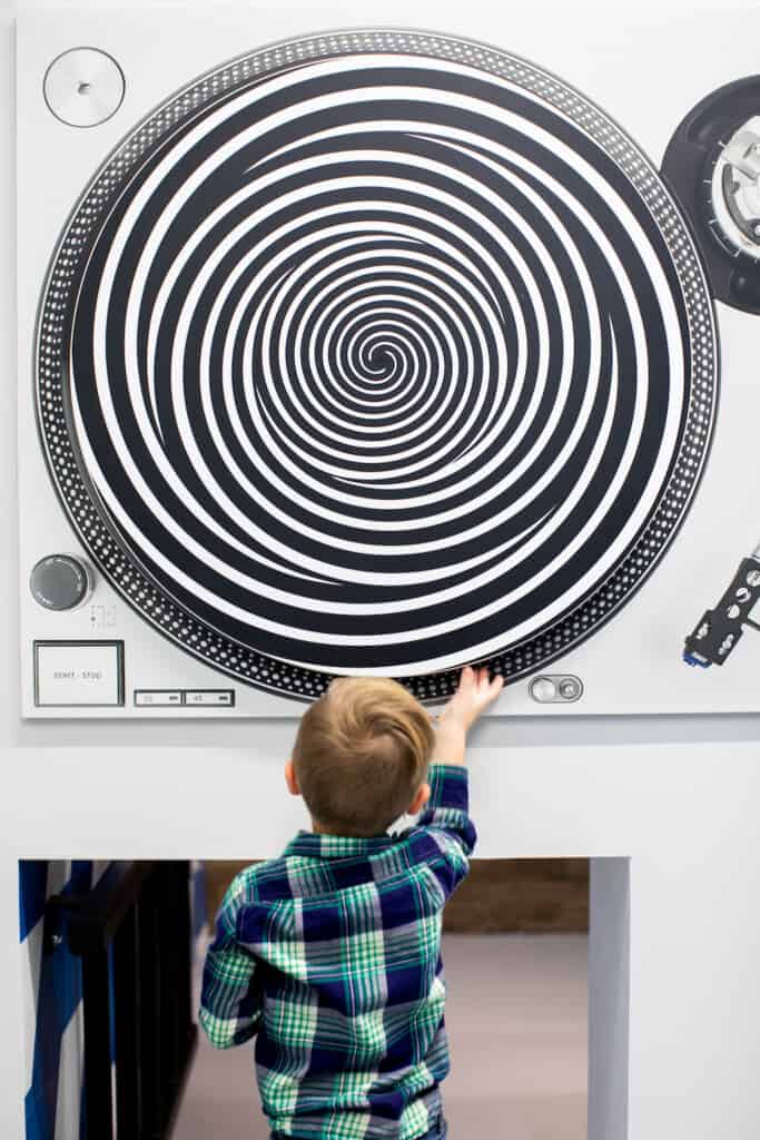 child explores a visual exhibit