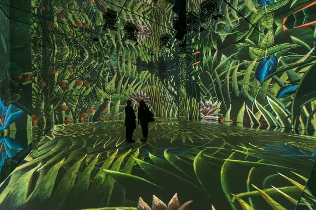 frameless blooloop innovation awards 2022 two people standing in forest projected room