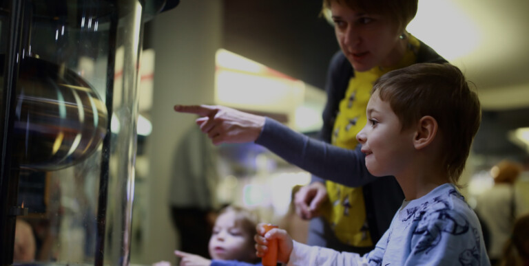 young-visitor-hands-on-museum-exhibit