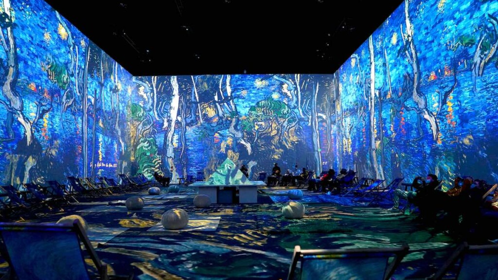 people sitting on the floor at an immersive Van Gogh experience from Fever