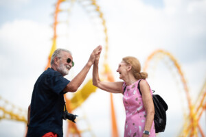 elderly senior couple woman and man having fun and happy together at amusement them park retirees