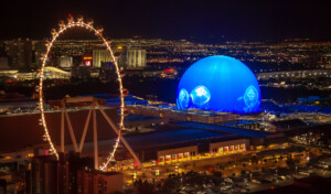 New MSG Sphere in Las Vegas next to High Roller wheel at night