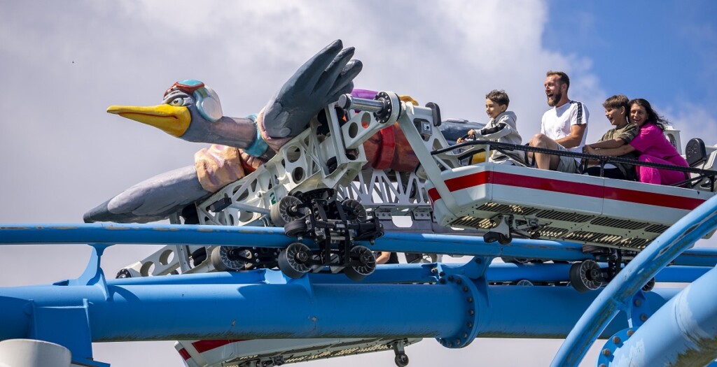 A family enjoys riding the Free Fly Coaster
